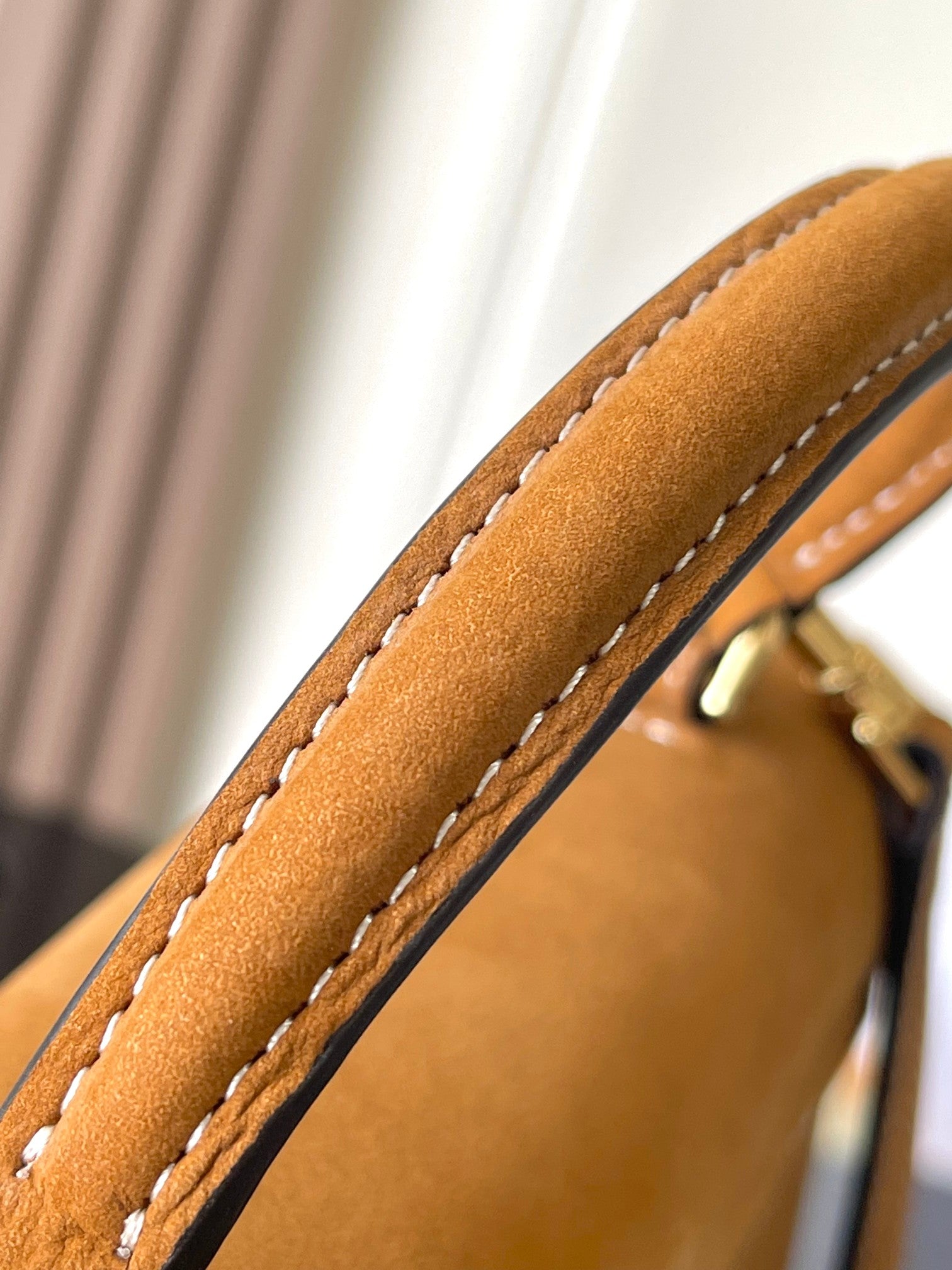 Celine tan leather bag close-up of stitched edge and textured strap corner