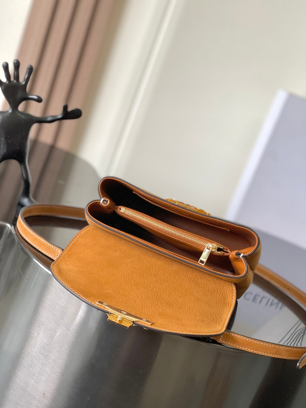Celine mini tan leather crossbody bag open top showing interior and gold latch