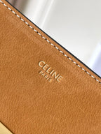 Celine tan leather bag front with embossed Celine Paris logo and white stitching