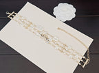 Chanel accessories: pearl and crystal chain bracelets with gold cross and bar charms