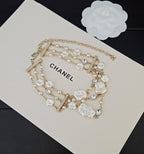 Chanel accessories: pearl and crystal charm necklace with CHANEL logo tag