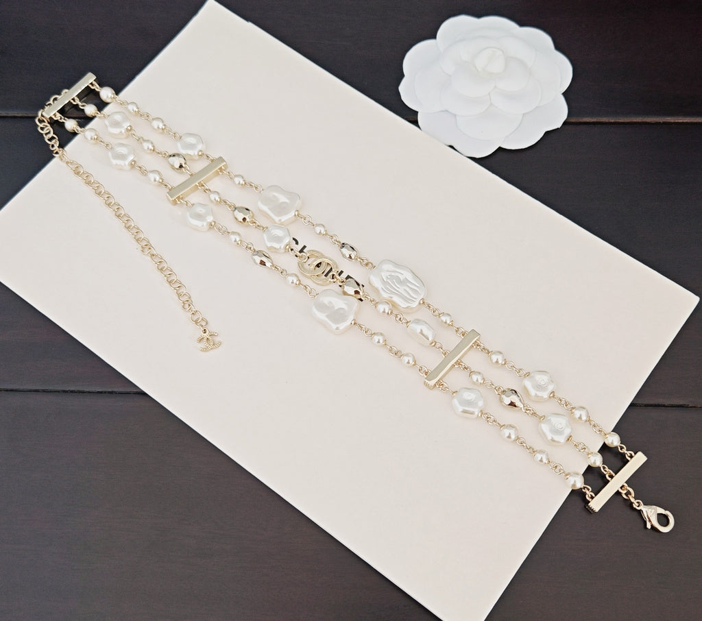 Chanel accessories: long layered pearl-bead chain bracelets with gold accents