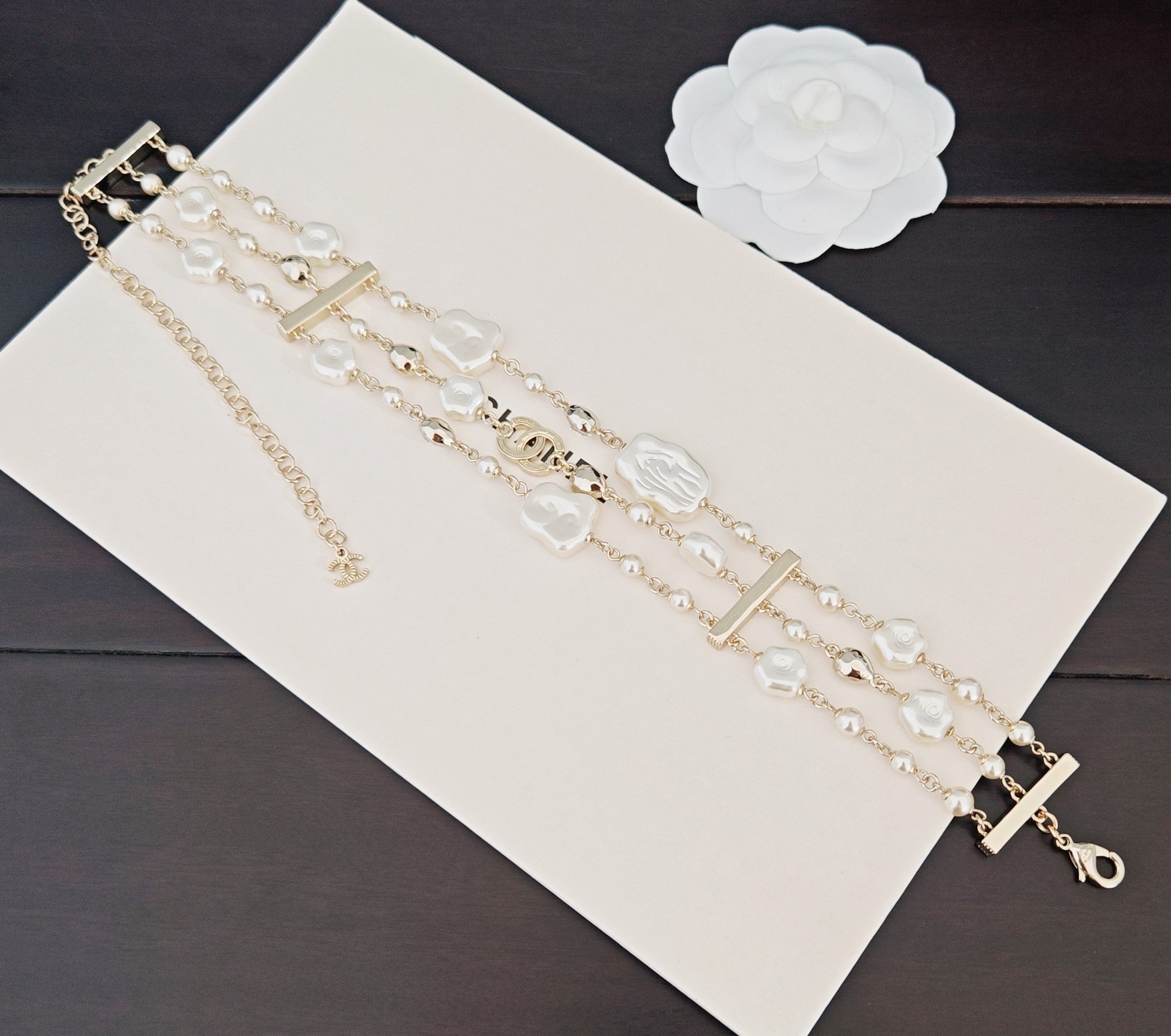 Chanel accessories: long layered pearl-bead chain bracelets with gold accents