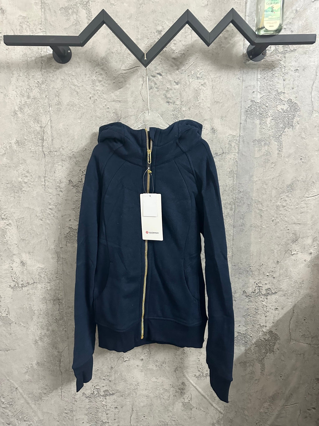 Dark navy zip-up hoodie with drawstring hood and full-length front zipper