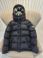 Puffer jacket with plaid hood lining, dark exterior, front zip and quilted padding