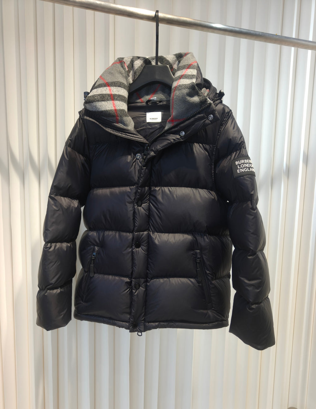 Puffer jacket with plaid hood lining, dark exterior, zip-front and padded design