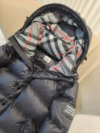Puffer jacket hood lining close-up with plaid pattern and dark exterior front