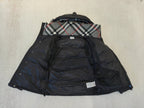 Puffer jacket interior view, dark lining with plaid hood yoke and two hanging tags