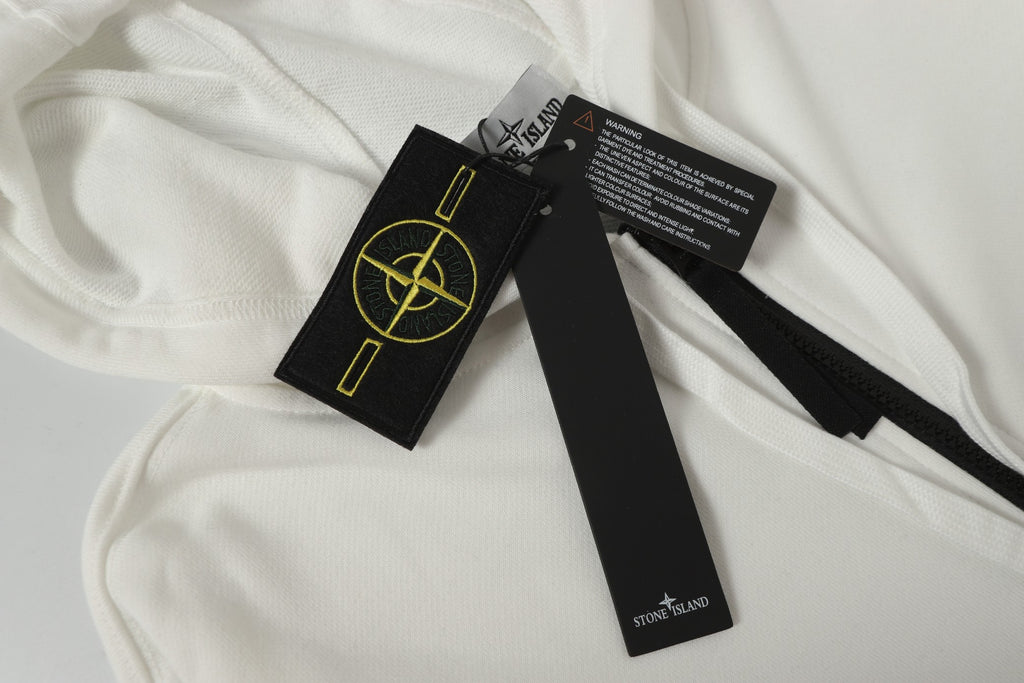 Stone Island label set on white hooded jacket fabric with care tags