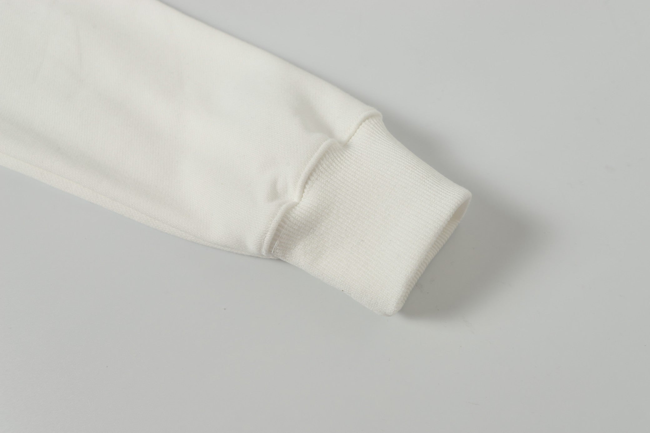 White jacket sleeve cuff with ribbed hem detail