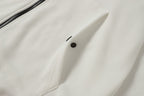 White hooded jacket front with button closure near chest pocket