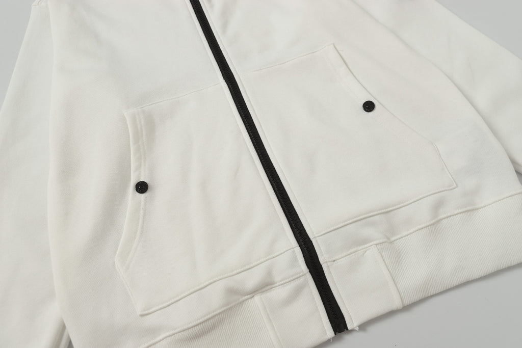 White hooded jacket showing two front flap pockets and black zipper