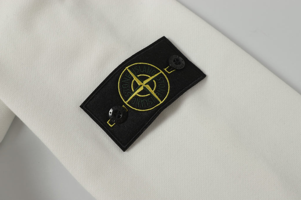Stone Island logo patch on white hooded jacket front near neckline