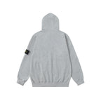 Light gray hoodie back with black sleeve brand patch and full hood