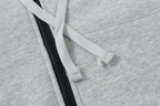 Light gray hoodie drawstring through hood with black zipper placket