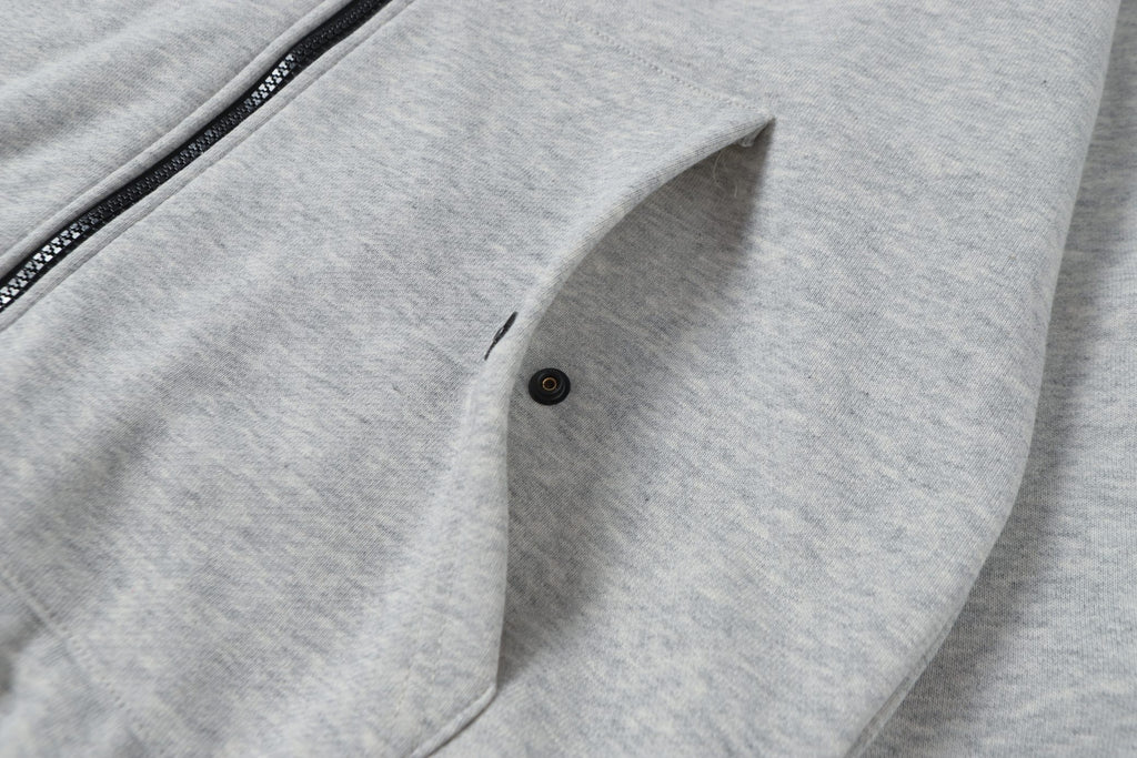 Light gray zip hoodie with front pocket and buttoned flap detail