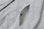 Light gray zip hoodie with front pocket and buttoned flap detail