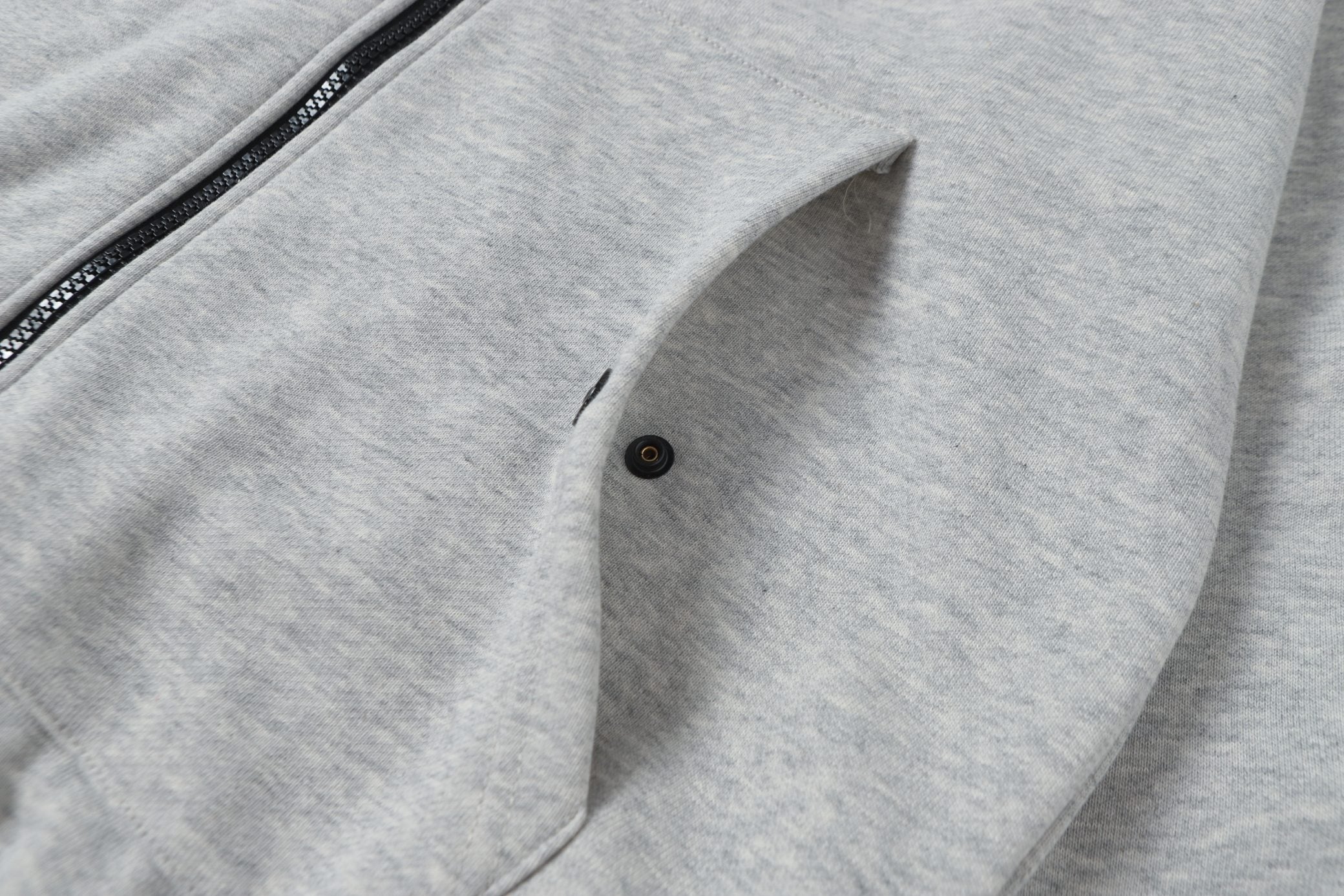 Light gray zip hoodie with front pocket and buttoned flap detail