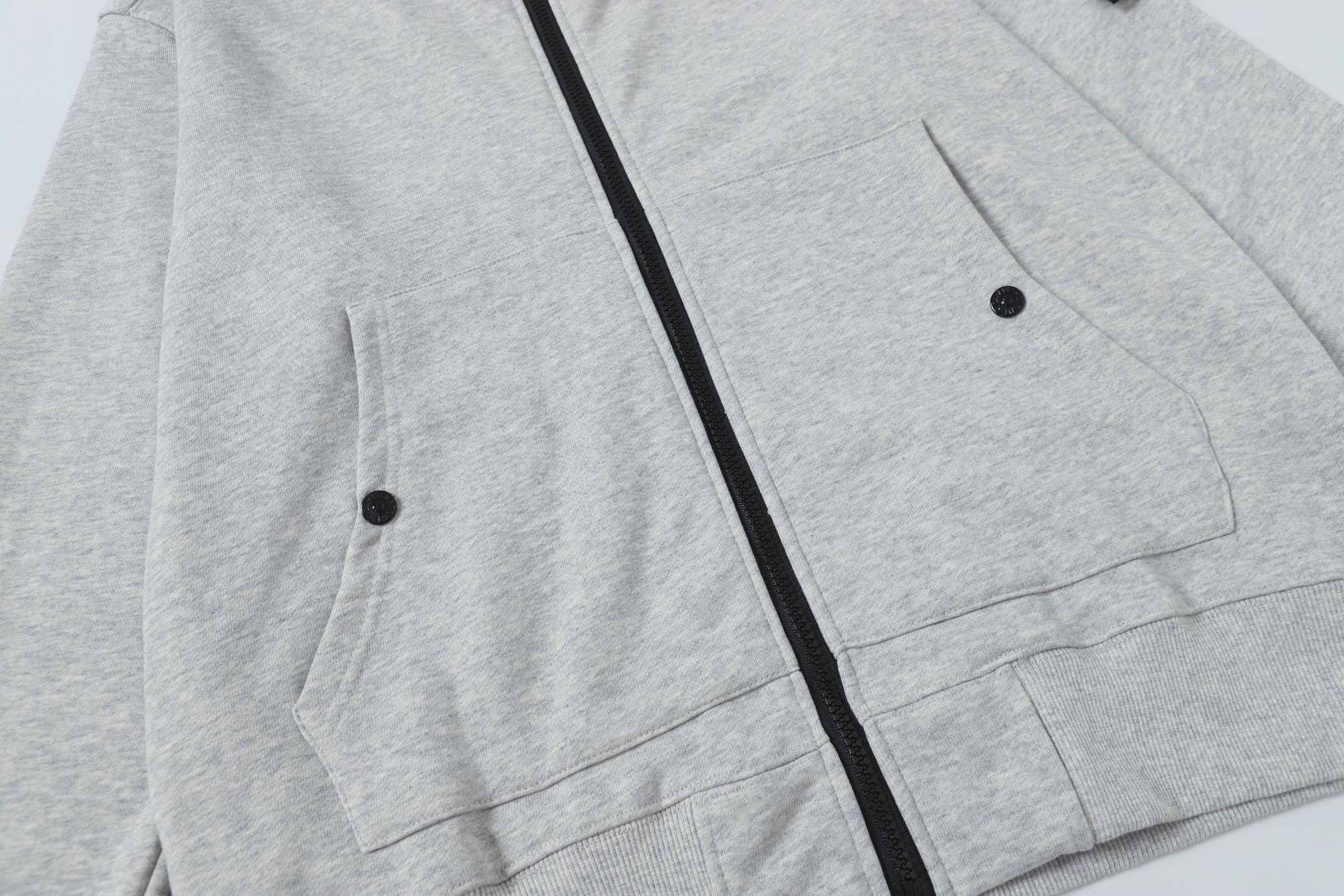 Light gray zip hoodie front with two pockets and black zipper