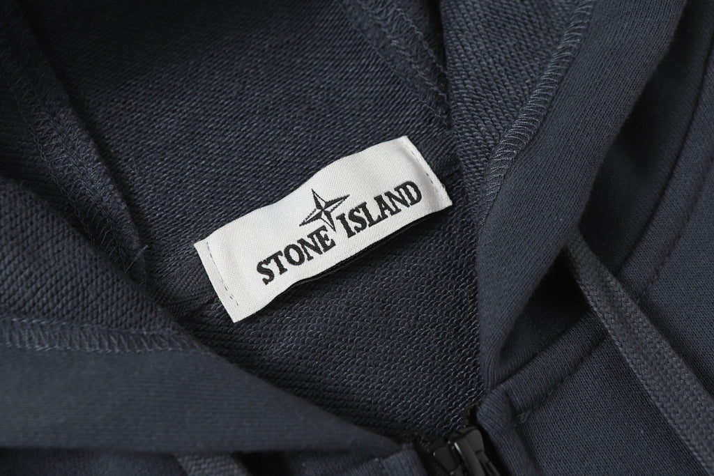 Stone Island neck label on dark navy hooded jacket collar