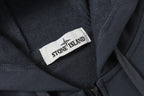 Stone Island neck label on dark navy hooded jacket collar