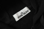 Stone Island woven neck label on black jacket fabric