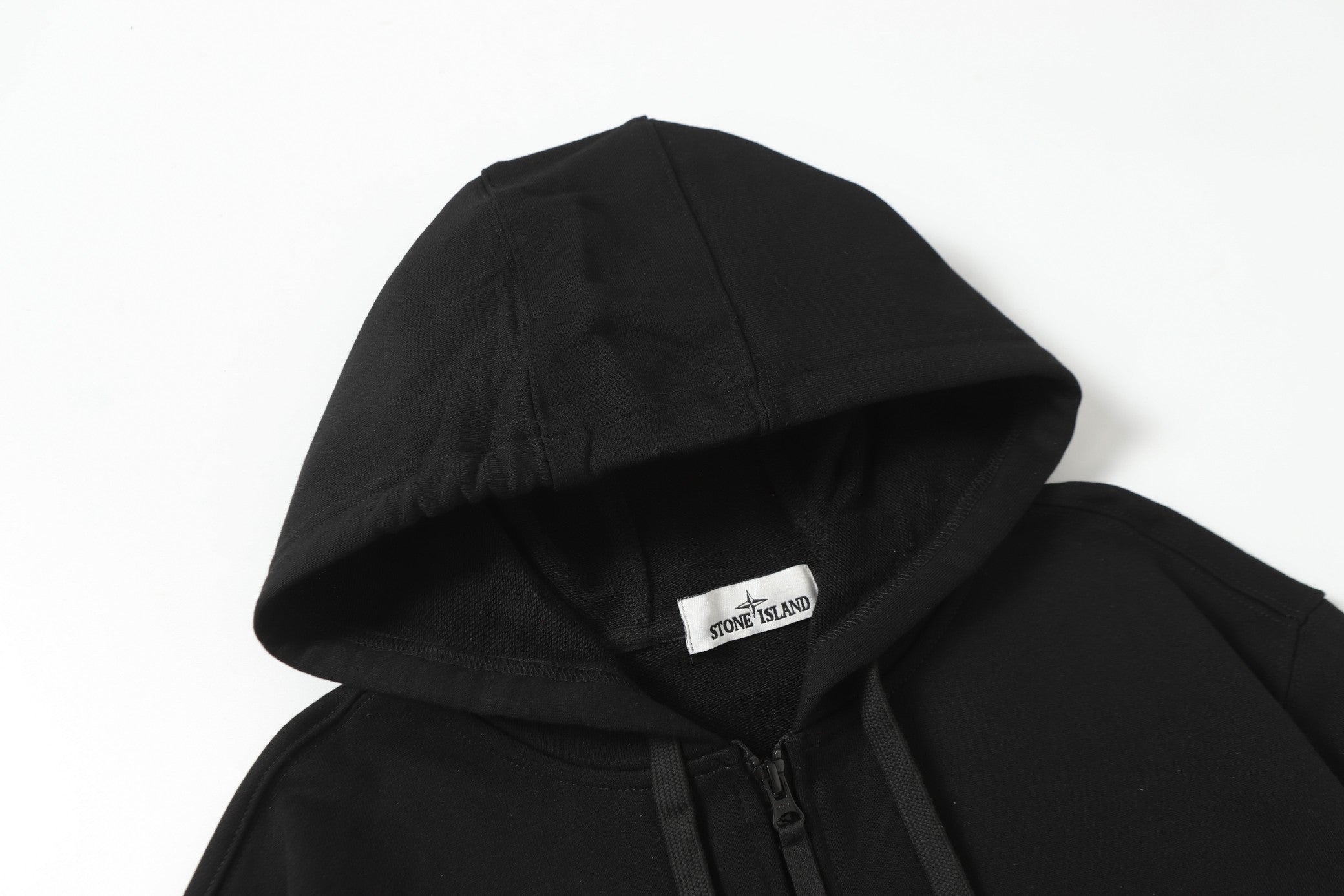 Black hooded zip jacket hood and front zipper detail