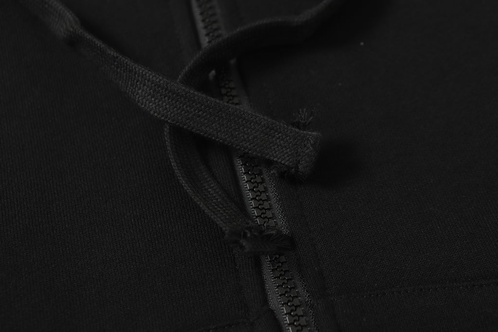 Black hooded jacket zipper and drawstring close-up