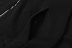 Black front pocket with snap buttons on hooded jacket