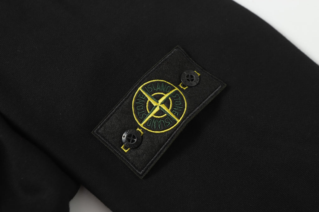 Dark garment with Stone Island logo patch on chest