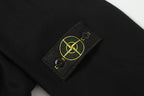 Dark garment with Stone Island logo patch on chest