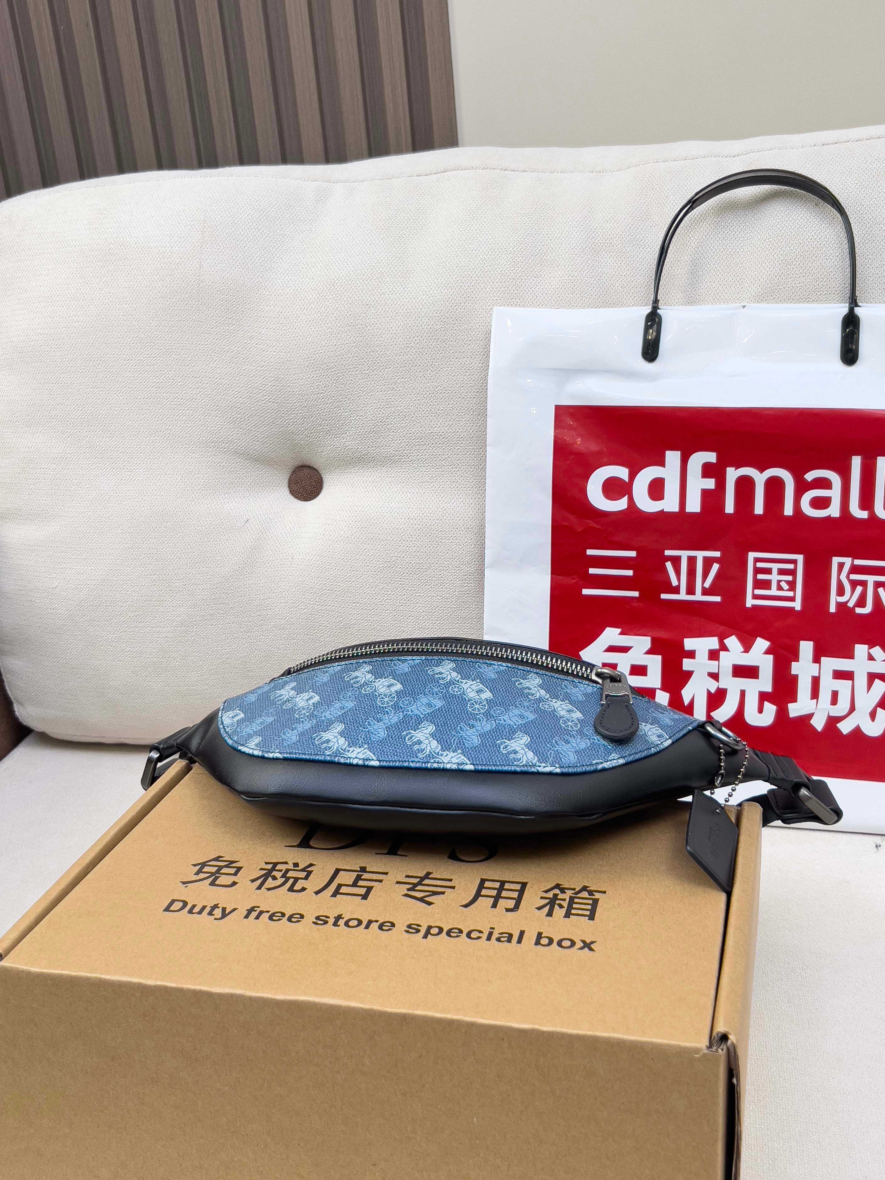 Coah belt bag, blue patterned with black strap, zip top and rear tab
