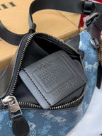 Coah crossbody bag detail, black zip pocket with embossed leather patch and strap