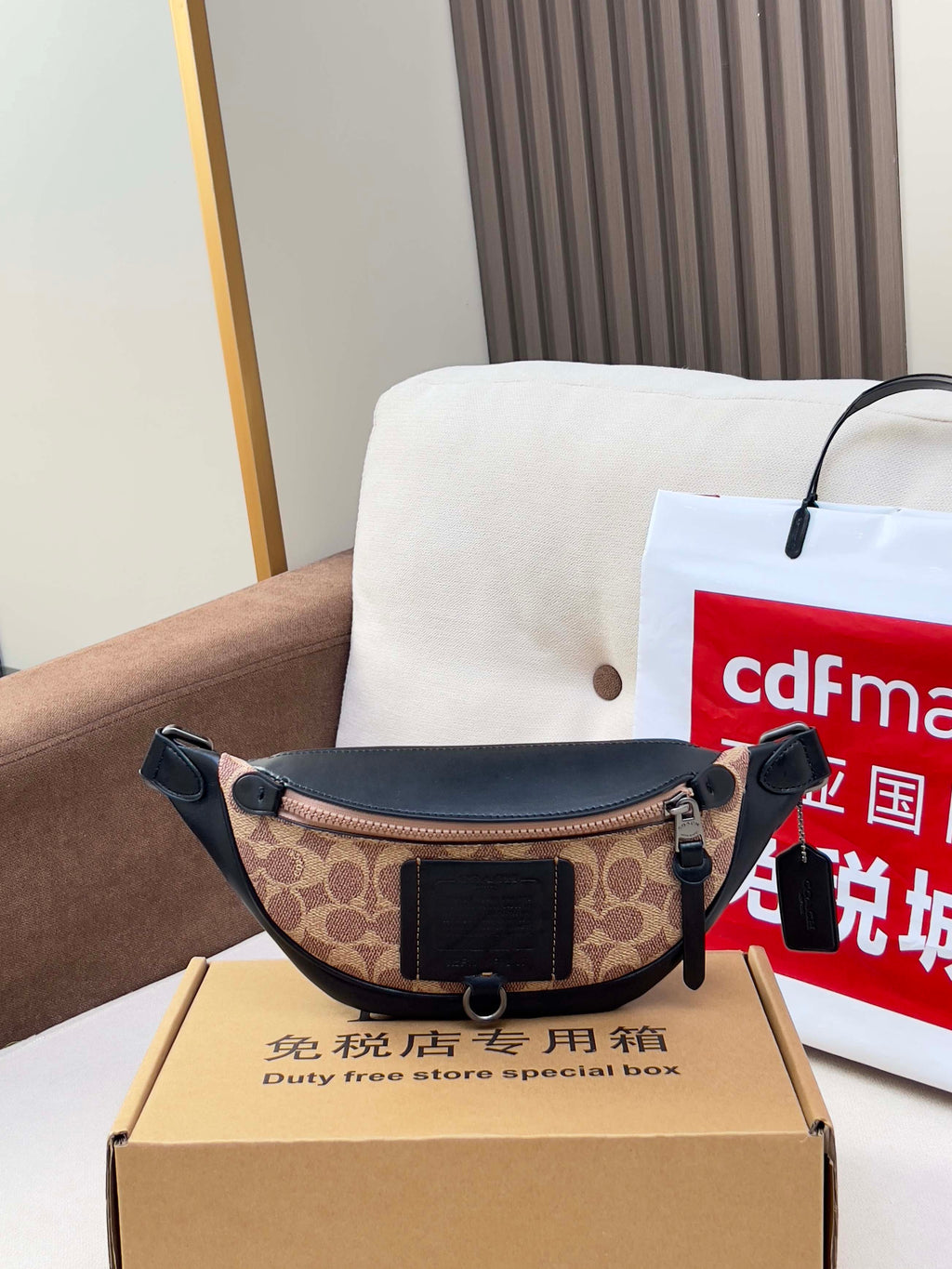 Coah monogram belt bag with black leather panels and adjustable strap
