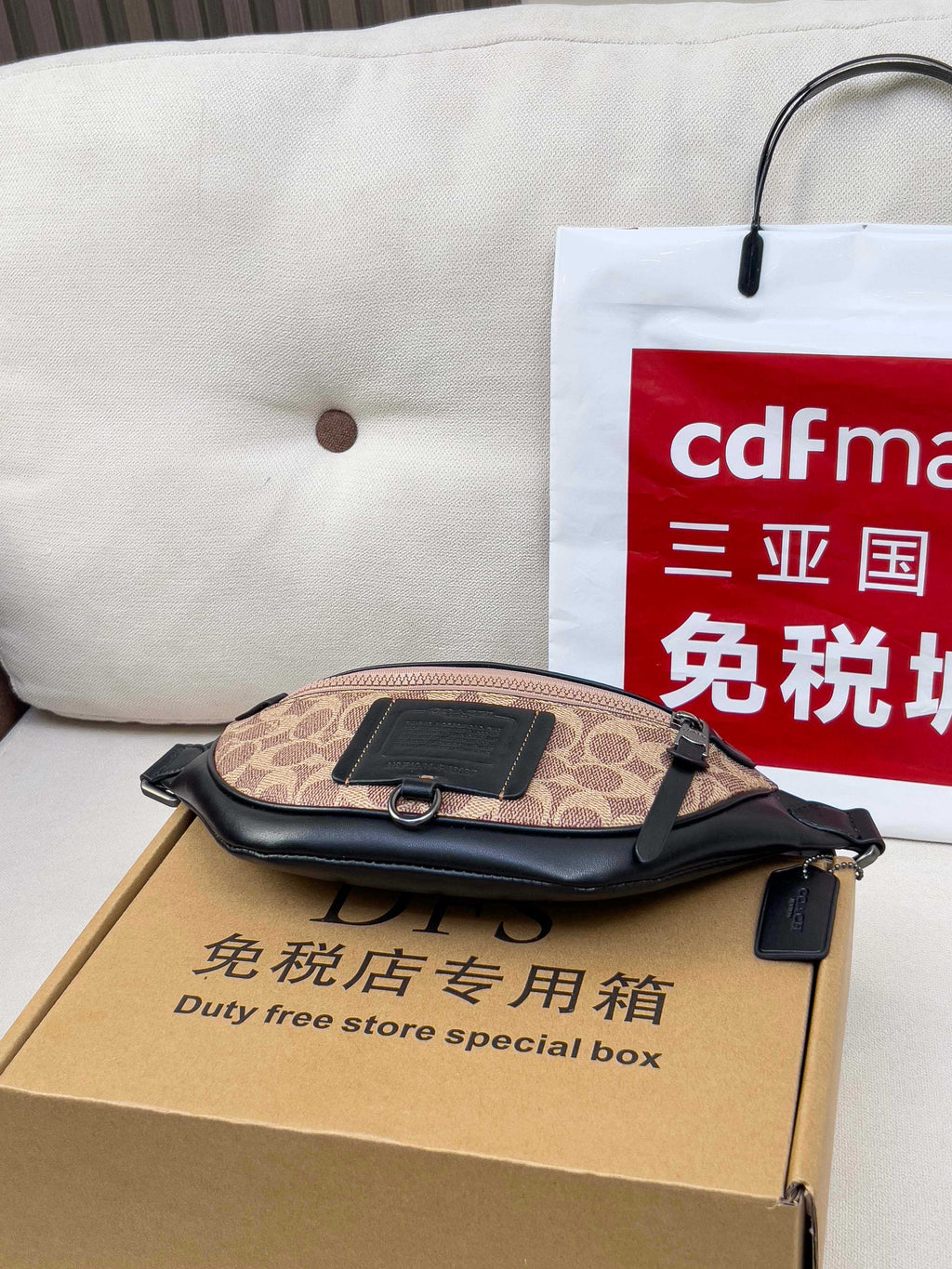 Coah monogram belt bag with black logo patch and zip top