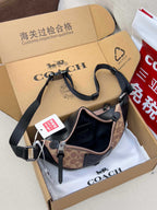 Coah monogram shoulder bag with black leather accents and zip opening