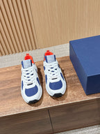 White and navy unisex low-top sneakers with red heel accents and lace-up front