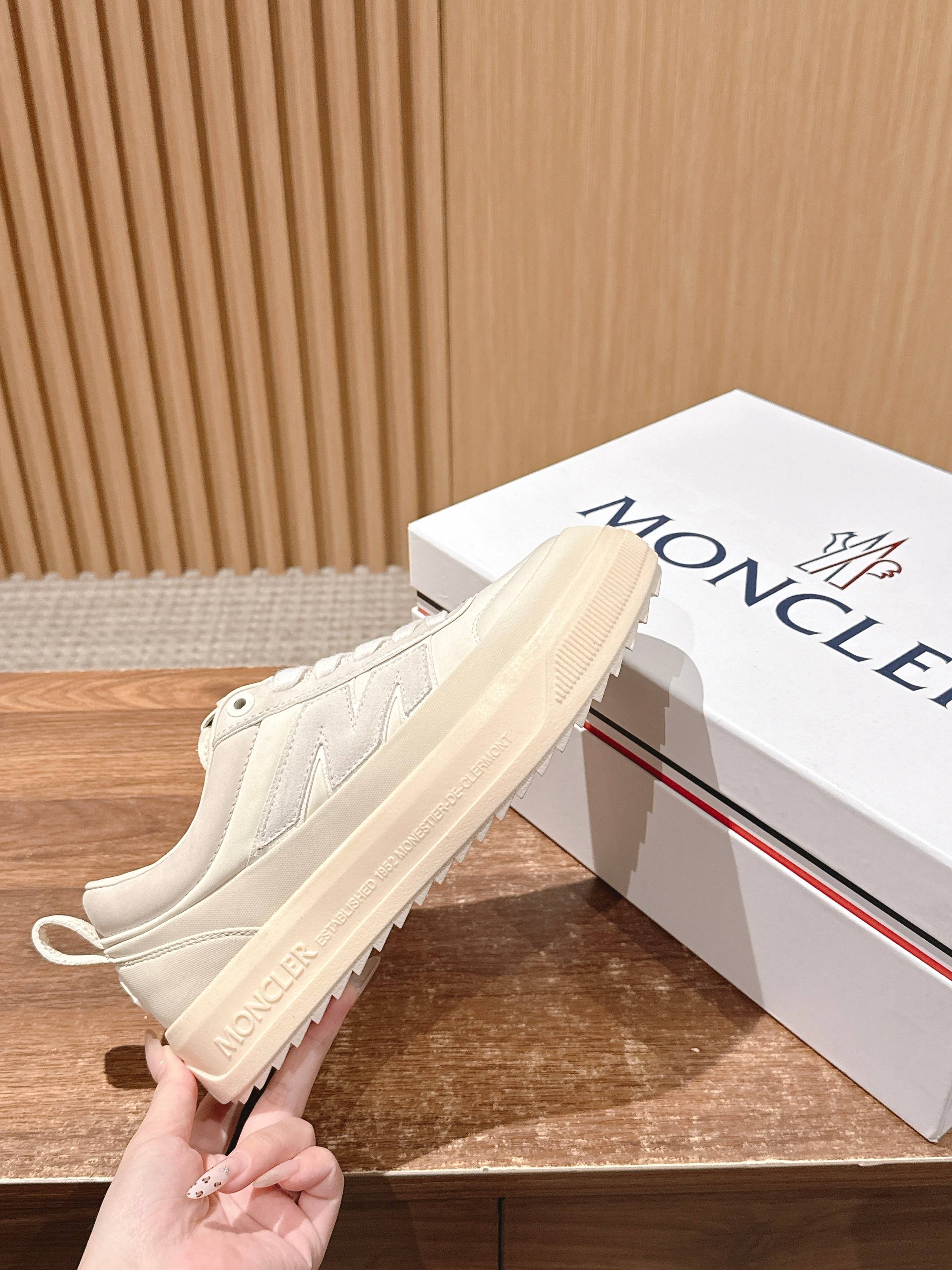 Moncler luxury shoes in cream, low-top with thick sole and visible side branding.