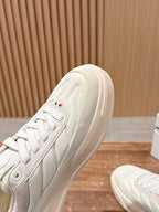 Moncler luxury shoes in cream, close-up of toe and lace panel with logo patch.