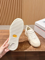 Moncler luxury shoes in cream, outsole view with ridged tread and lace-up shoe top.