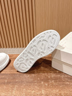 White rubber sneaker outsole with textured tread, side view
