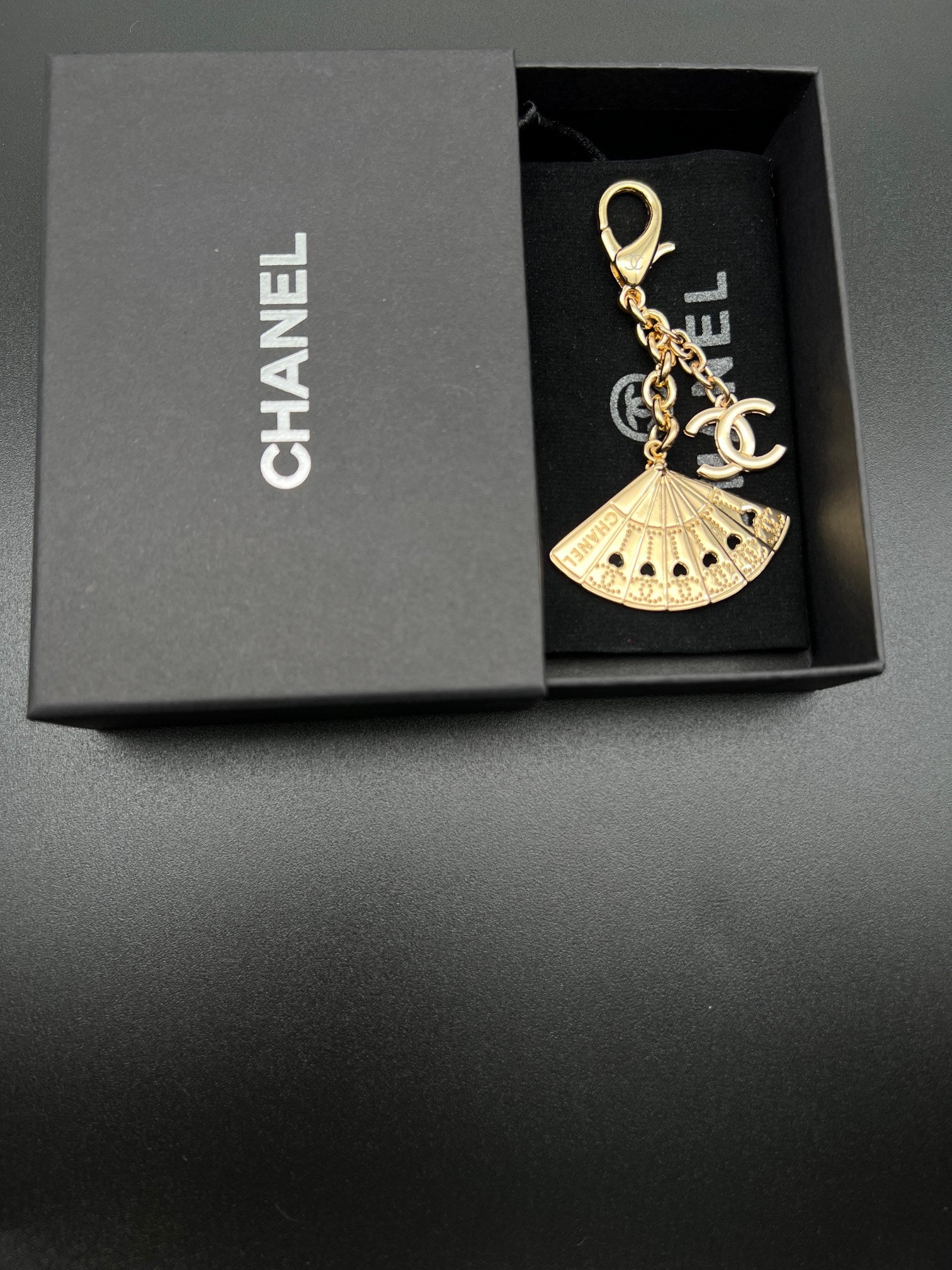 Chanel gold fan charm with chain and clasp in black gift box