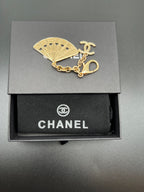 Chanel blue fan charm with gold chain and clasp on black gift box