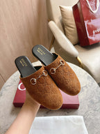 Gucci unisex tan GG mules with gold-tone horsebit, on display with dust bag