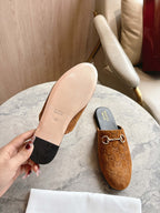 Gucci unisex tan GG mules with visible outsole and gold-tone horsebit