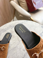 Gucci unisex tan GG mules with black footbed and gold-tone horsebit