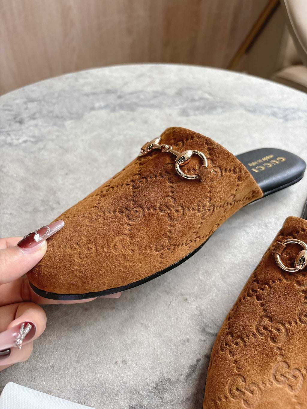 Gucci unisex tan GG mule close-up with gold-tone horsebit