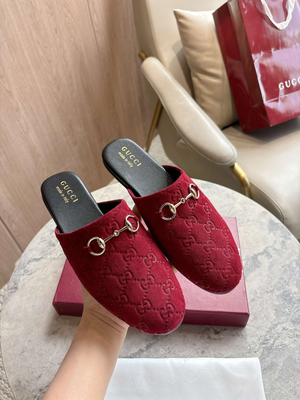 Gucci unisex horsebit mules, dark red GG-textured velvet with gold bit detail on display box