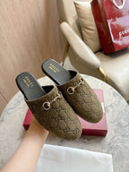 Gucci unisex slide mules with olive-brown GG canvas uppers and gold-tone horsebit detail.