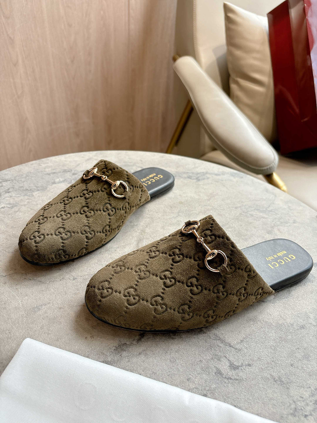 Pair of Gucci unisex slide mules in olive-brown GG canvas with gold-tone horsebit hardware.